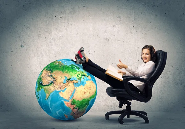 Businesswoman sitting in chair with book — Stock Photo, Image