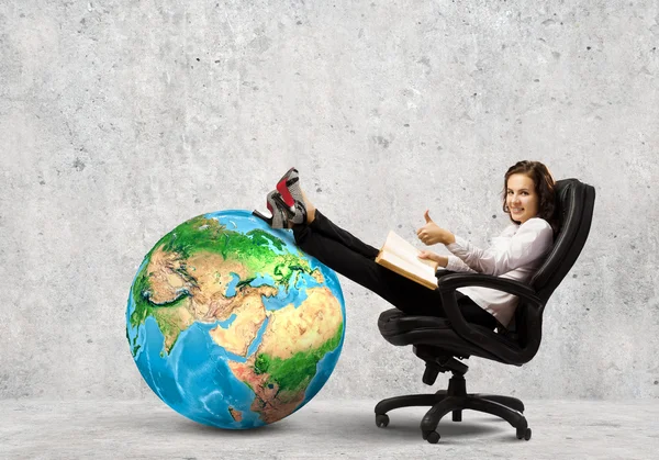 Businesswoman sitting in chair with book — Stock Photo, Image