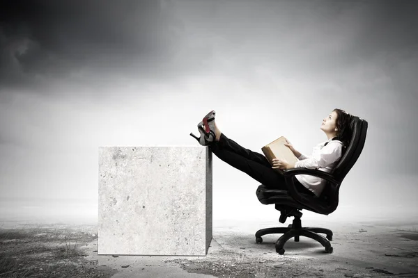 Businesswoman sitting with book — Stock Photo, Image