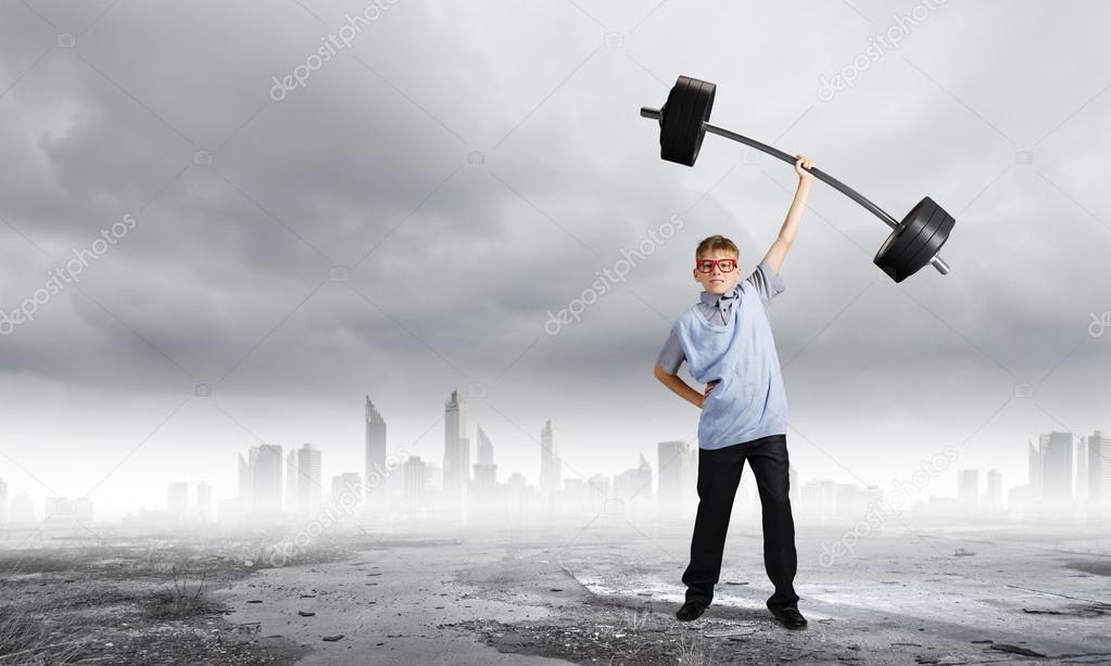 Boy lifting barbell above head