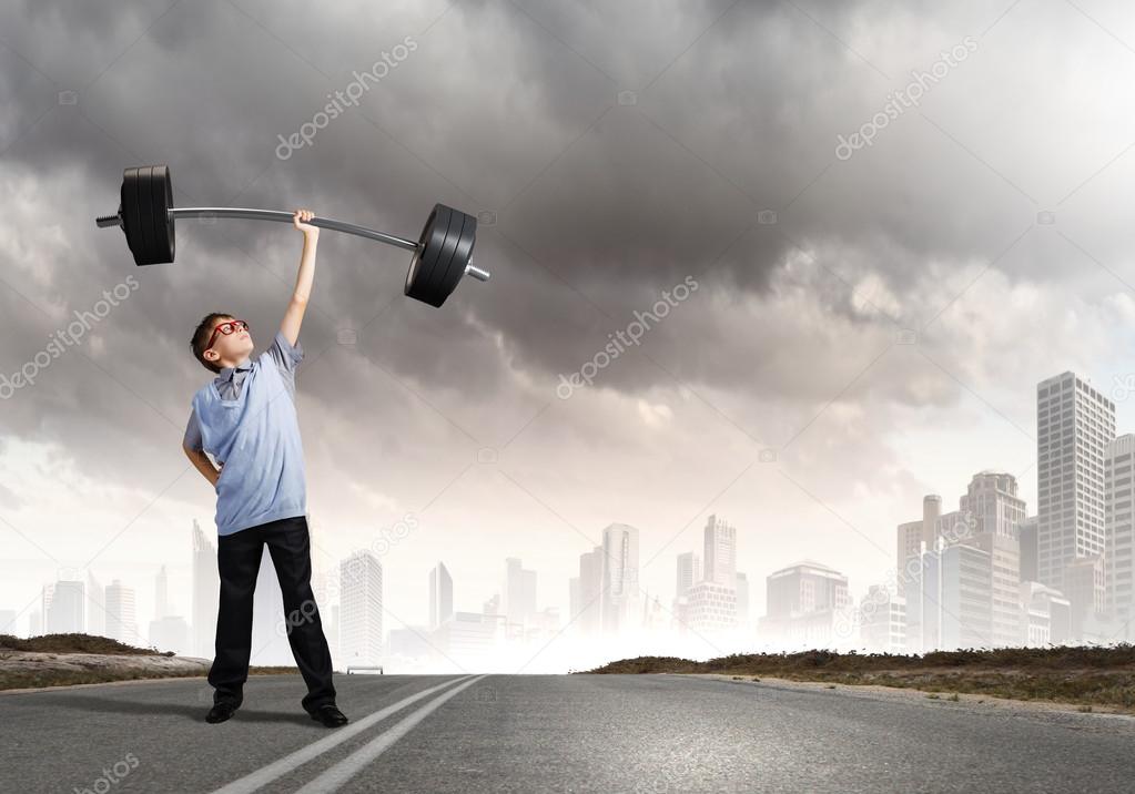 Boy lifting barbell above head