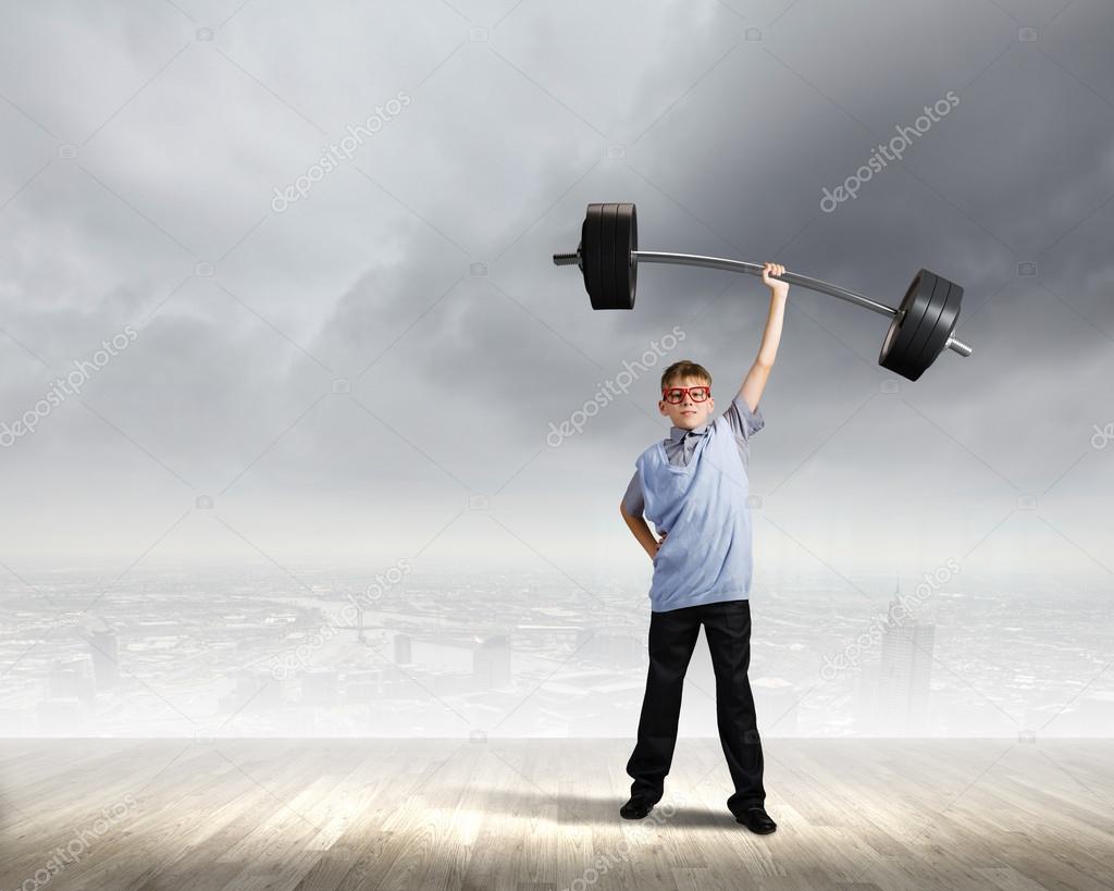 Boy lifting barbell above head