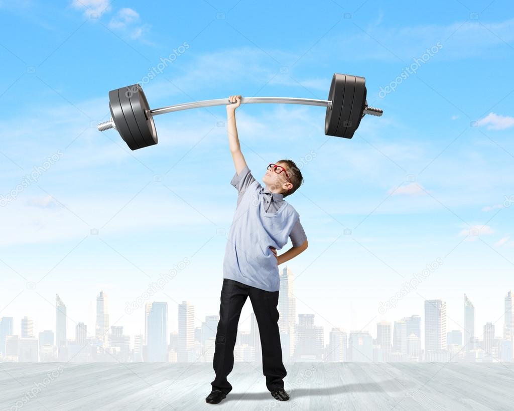 Boy lifting barbell above head