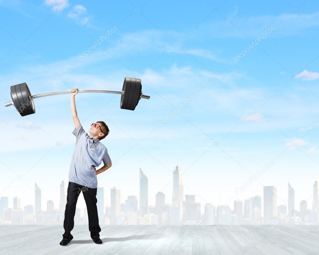 Boy lifting barbell above head