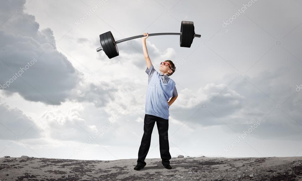 Boy lifting barbell above head