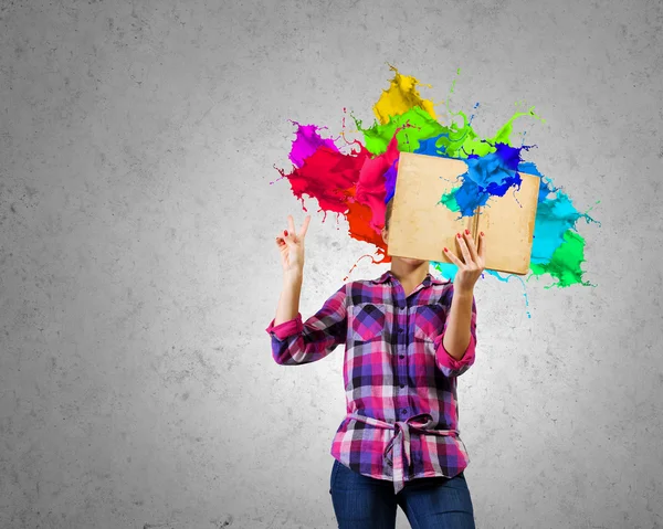 Woman  hiding face behind reading — Stock Photo, Image