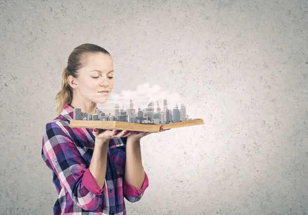 Woman holding book with city model — Stock Photo, Image