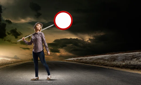 Woman holding road sign — Stock Photo, Image