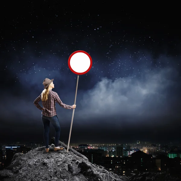 Woman holding road sign — Stock Photo, Image