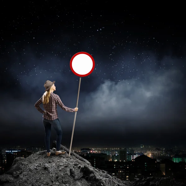 Woman holding road sign — Stock Photo, Image