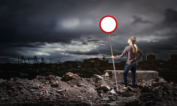 Woman holding road sign — Stock Photo, Image