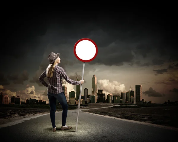 Woman holding road sign — Stock Photo, Image