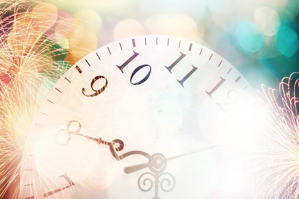 Clock with bokeh lights and firework — Stock Photo, Image