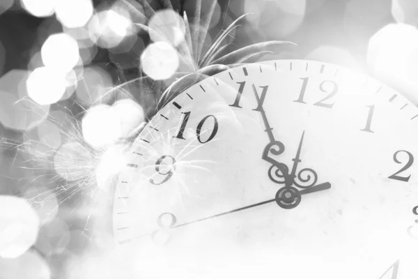 Clock with bokeh lights and firework — Stock Photo, Image