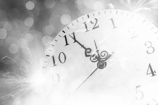 Clock with bokeh lights and firework — Stock Photo, Image