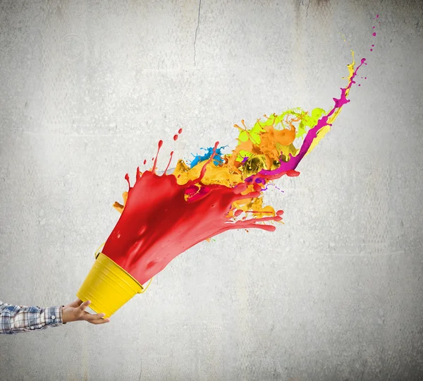 Hand splashing colorful paint — Stock Photo, Image