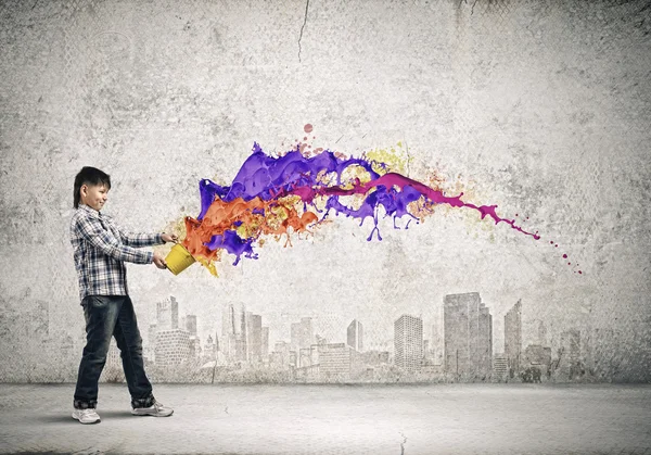 Boy splashing colorful paint — Stock Photo, Image