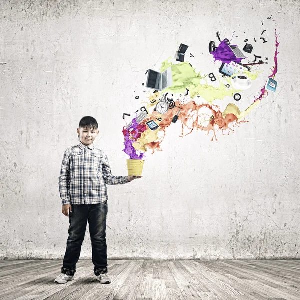 Boy splashing colorful paint — Stock Photo, Image