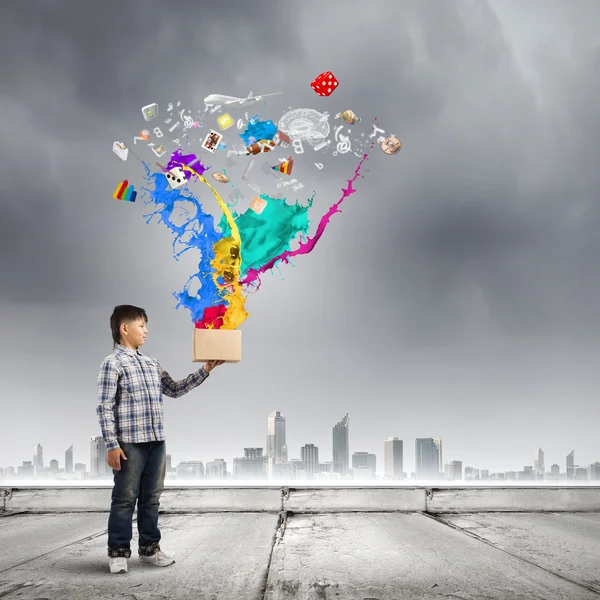 Boy splashing colorful paint — Stock Photo, Image