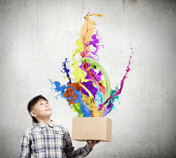 Boy splashing colorful paint — Stock Photo, Image