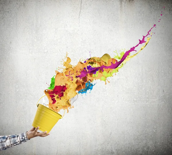 Hand splashing colorful paint — Stock Photo, Image