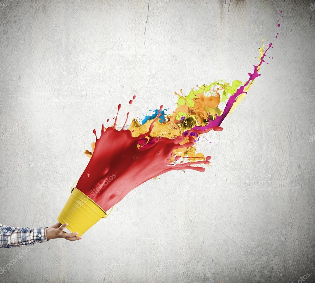 Hand splashing colorful paint