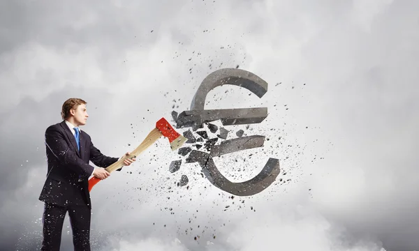 Businessman breaking euro sign — Stock Photo, Image