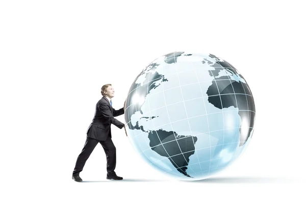 Businessman pushing big Earth planet. — Stock Photo, Image