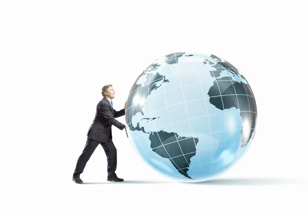 Businessman pushing big Earth planet. — Stock Photo, Image