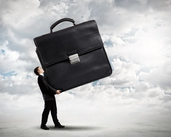 Businessman carrying heavy suitcase — Stock Photo, Image