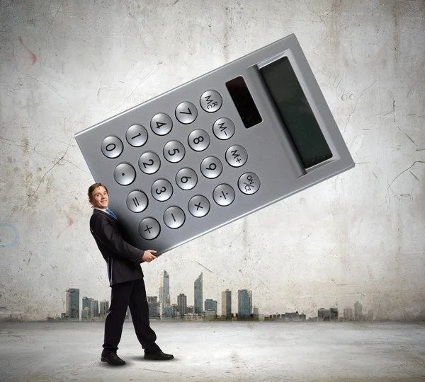 Businessman carrying big calculator — Stock Photo, Image