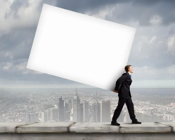 Businessman carrying white cube — Stock Photo, Image