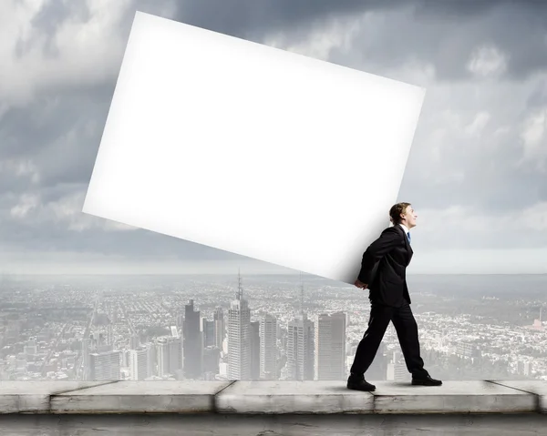 Businessman carrying white cube — Stock Photo, Image