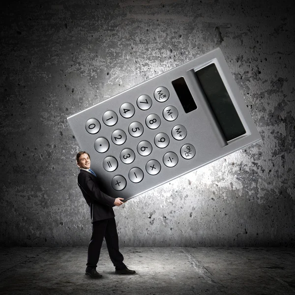 Businessman carrying big calculator — Stock Photo, Image
