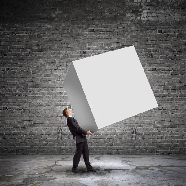 Бизнесмен с белым кубом — стоковое фото