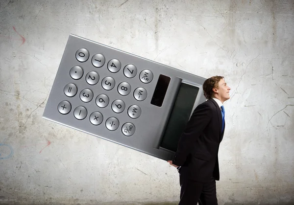 Businessman carrying big calculator — Stock Photo, Image