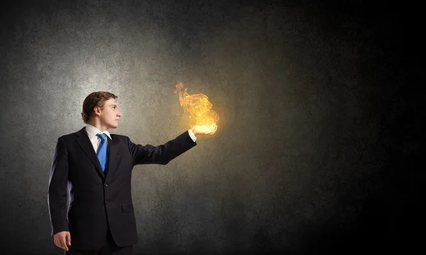 Businessman holding fire flames — Stock Photo, Image