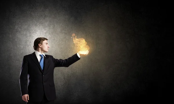 Businessman holding fire flames — Stock Photo, Image