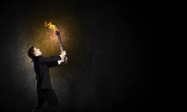 Businessman holding torch — Stock Photo, Image