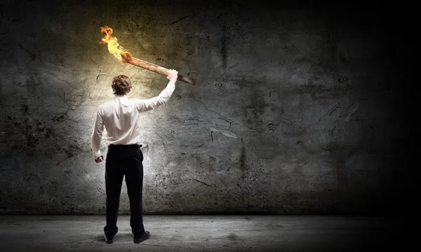 Businessman holding torch — Stock Photo, Image