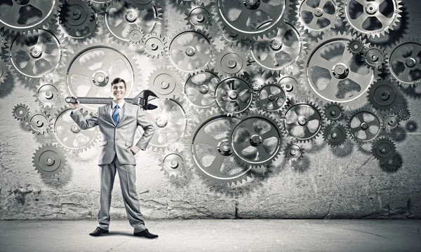 Young businessman with wrench — Stock Photo, Image