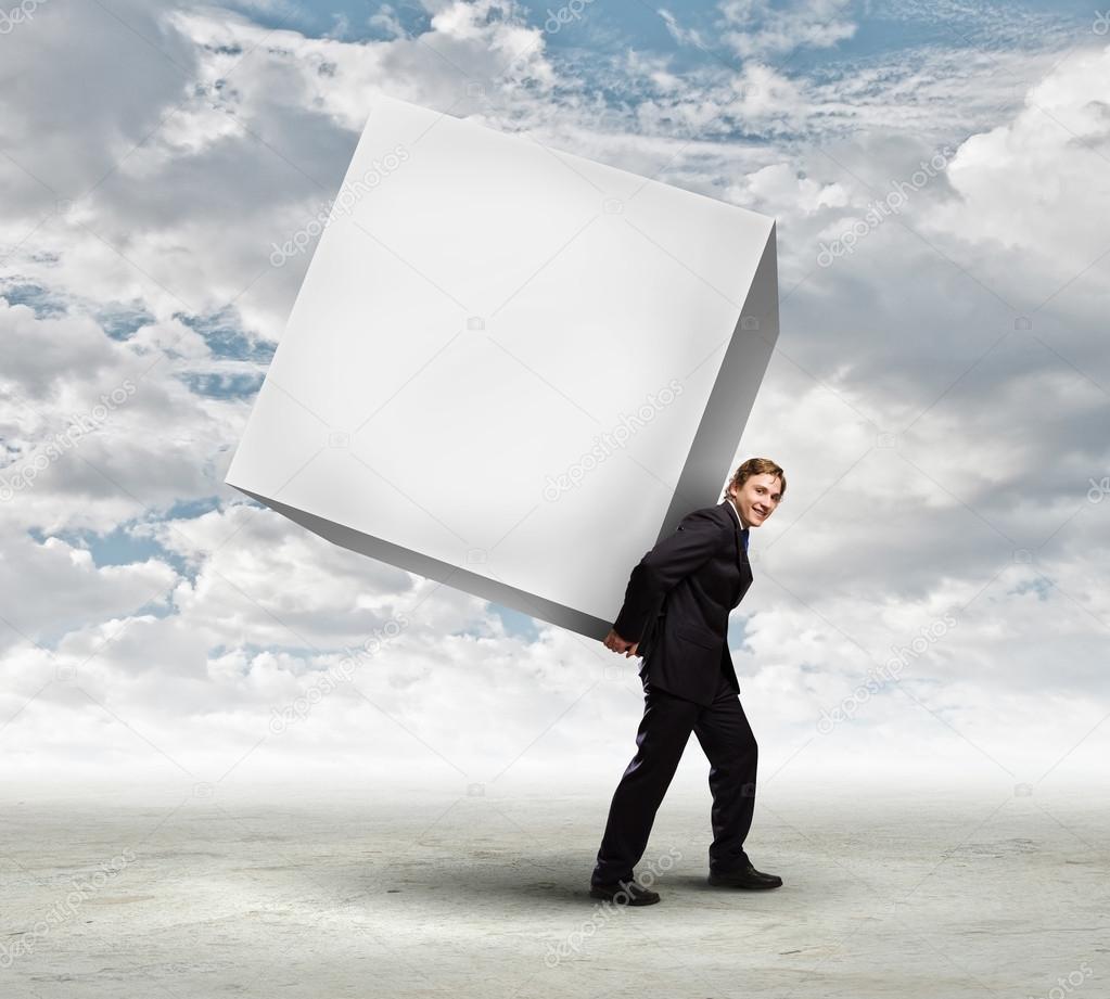 Businessman carrying white cube