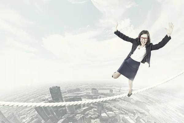 Mujer de negocios arriesgado equilibrio en la cuerda — Foto de Stock