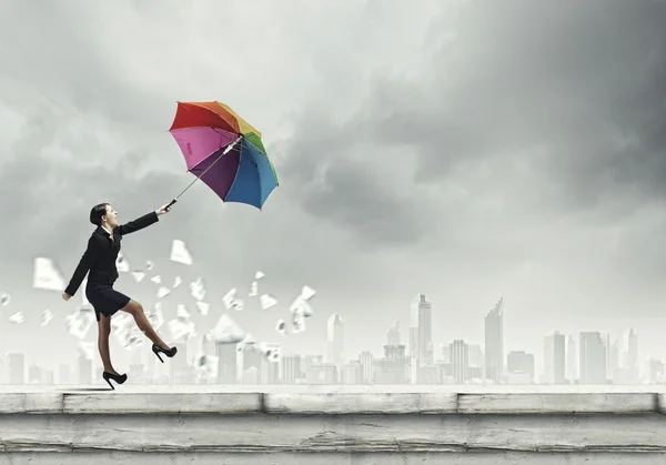 Businesswoman with colorful umbrella — Stock Photo, Image