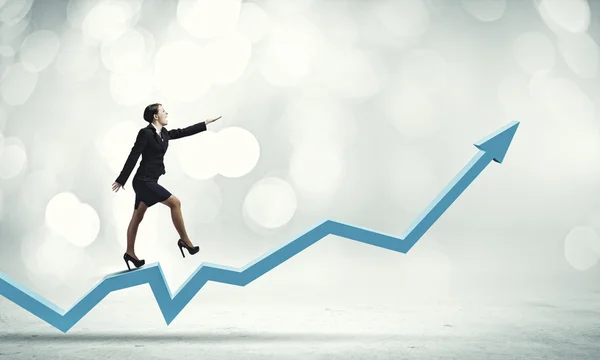 Businesswoman walking on increasing graph — Stock Photo, Image