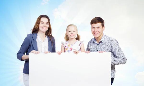 Family with white blank banner — Stock Photo, Image