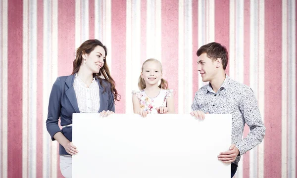Family with white blank banner — Stock Photo, Image