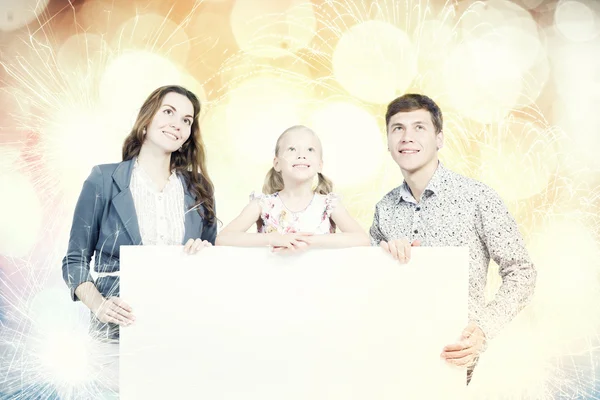 Family with white blank banner — Stock Photo, Image