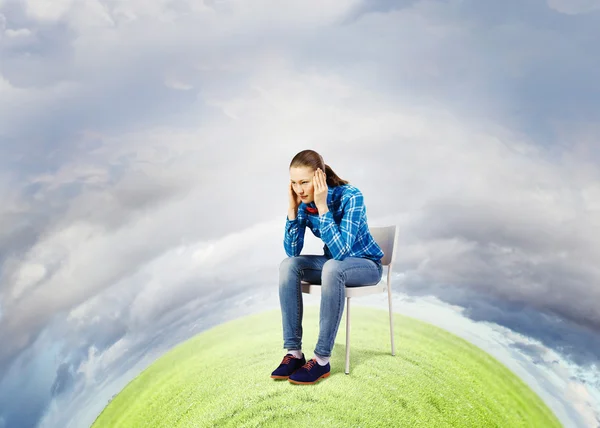 Woman sitting in chair on green planet — Stock Photo, Image