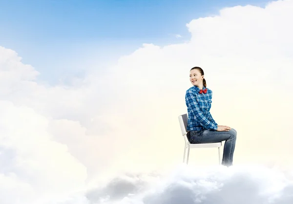 Woman sitting on cloud — Stock Photo, Image